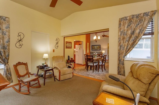 living room featuring ceiling fan, carpet, and lofted ceiling