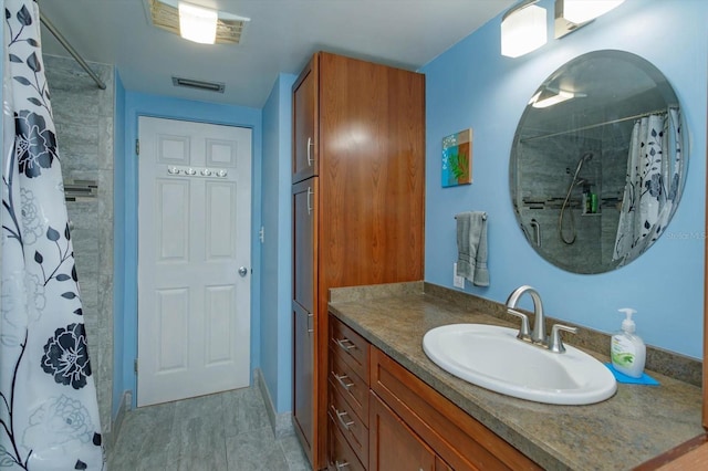 bathroom featuring vanity and a shower with shower curtain