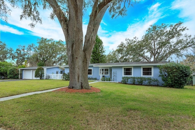 single story home with a garage and a front lawn