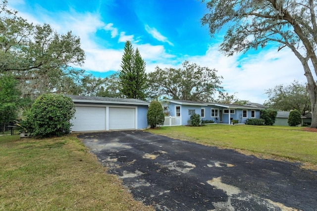 single story home featuring a garage and a front lawn