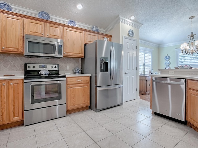 kitchen featuring light tile patterned flooring, hanging light fixtures, a textured ceiling, appliances with stainless steel finishes, and backsplash