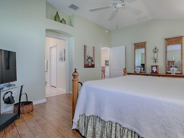 bedroom featuring lofted ceiling, light hardwood / wood-style floors, and ceiling fan