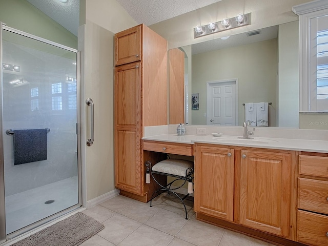 bathroom featuring vaulted ceiling, a shower with shower door, tile patterned flooring, vanity, and a textured ceiling