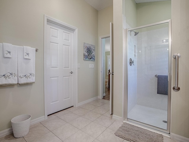 bathroom with tile patterned floors and a shower with shower door