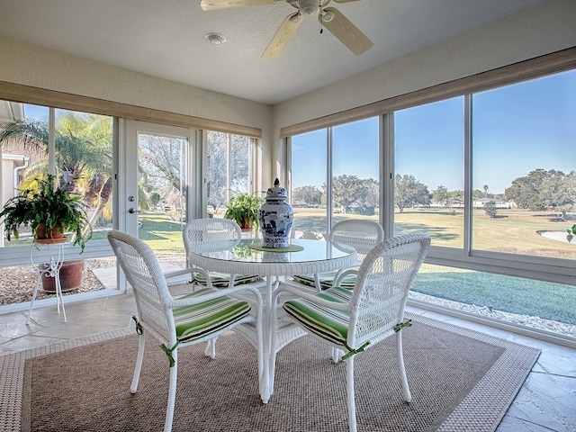 sunroom / solarium featuring ceiling fan