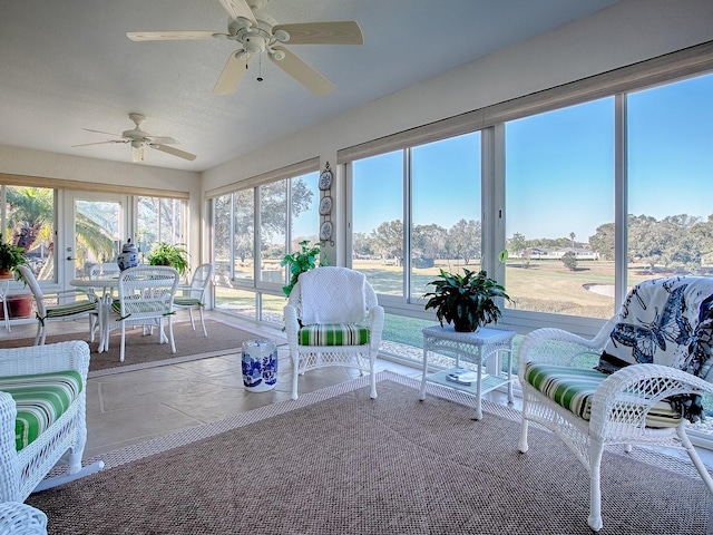 sunroom / solarium featuring ceiling fan