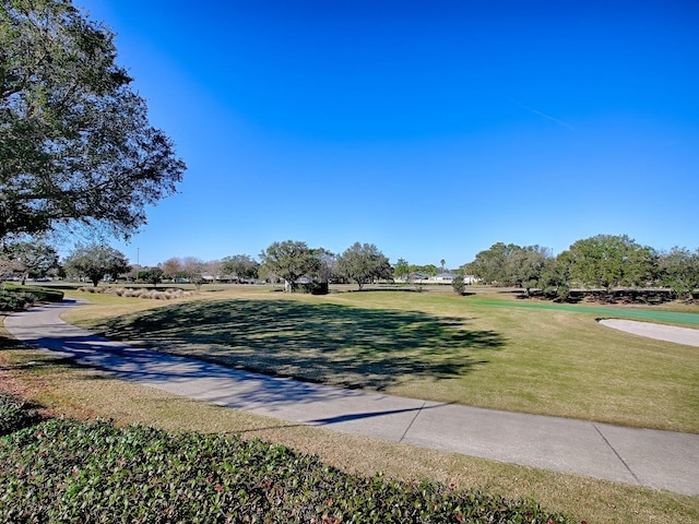 view of property's community with a lawn