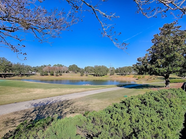 surrounding community with a water view and a yard