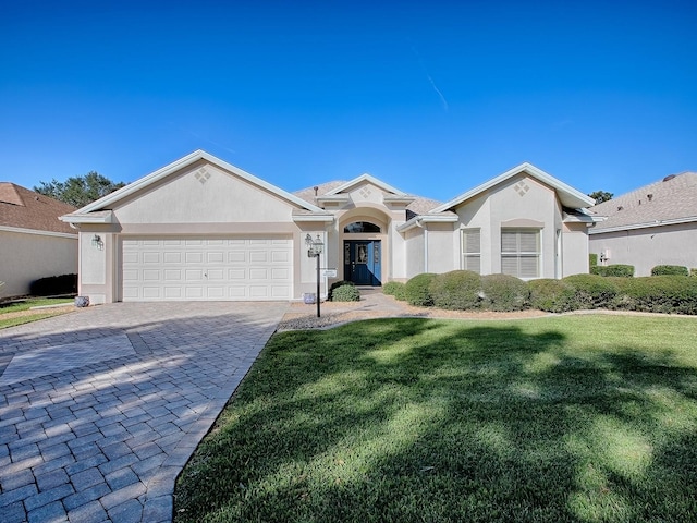 single story home with a garage and a front yard