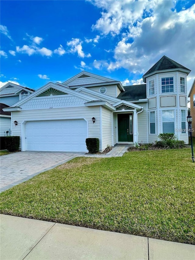 view of front of home featuring a garage and a front lawn