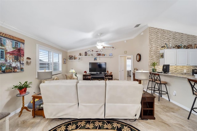 living room with ceiling fan, vaulted ceiling, and crown molding