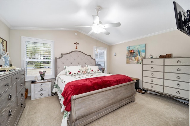 bedroom with ornamental molding, light colored carpet, vaulted ceiling, and a ceiling fan