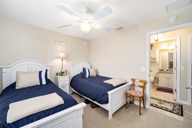 bedroom featuring ceiling fan and ensuite bath