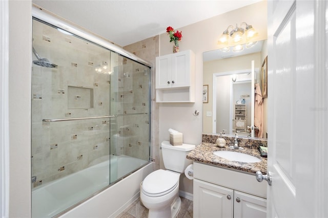 full bathroom with toilet, bath / shower combo with glass door, and vanity