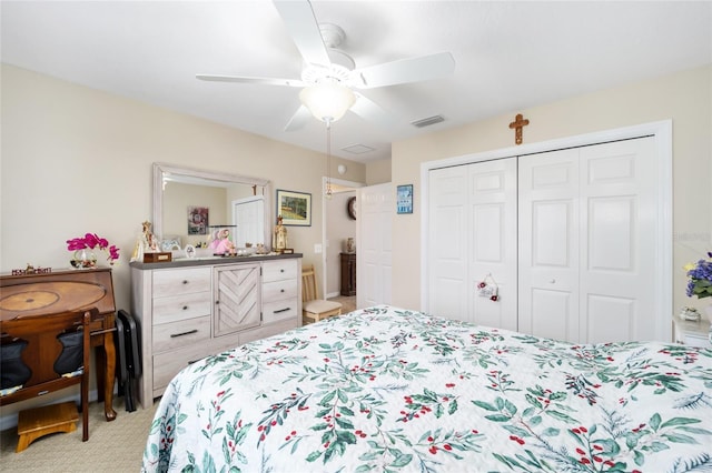 carpeted bedroom with ceiling fan and a closet