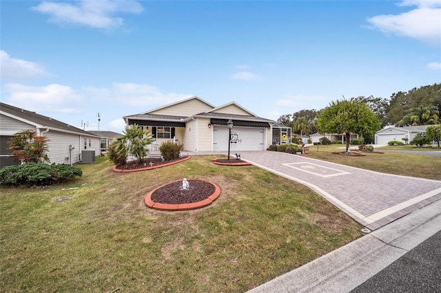 ranch-style house with an attached garage, central AC unit, decorative driveway, and a front yard