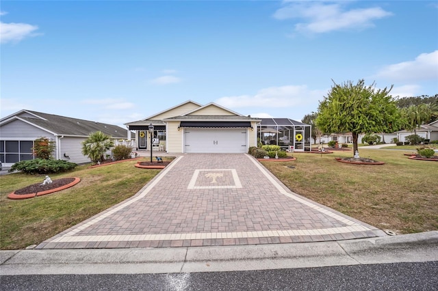 ranch-style home with a front yard, decorative driveway, glass enclosure, and an attached garage