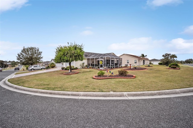 view of front of house with glass enclosure and a front yard