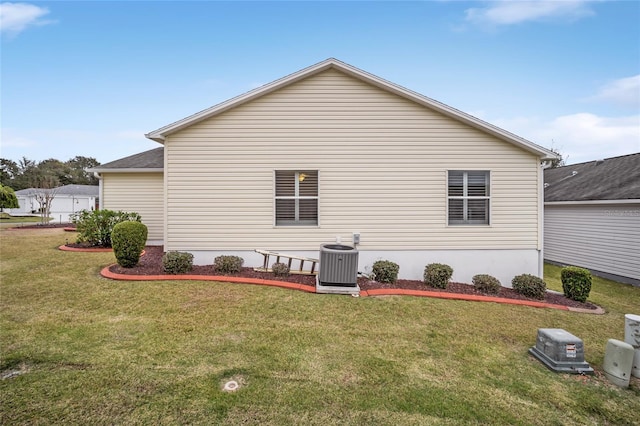 view of side of home featuring a yard and central air condition unit