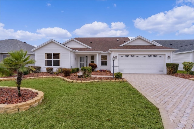 single story home featuring a garage and a front yard