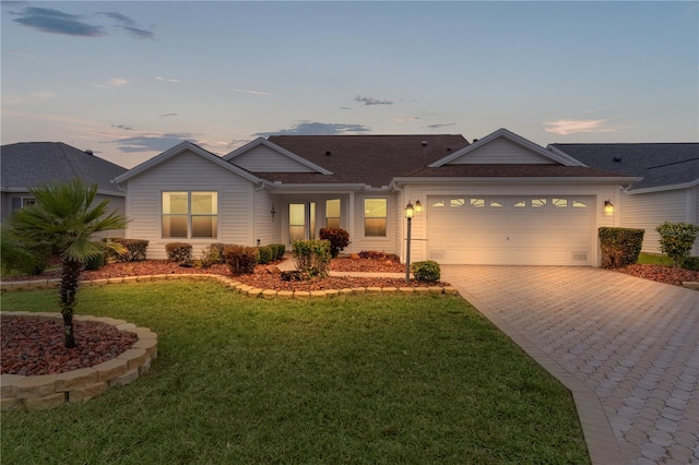 view of front of home featuring a yard and a garage