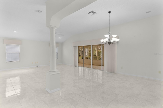 empty room featuring decorative columns, vaulted ceiling, and ceiling fan