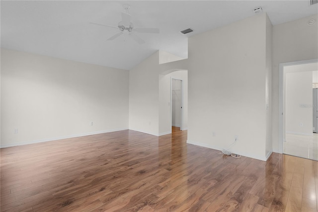 empty room with high vaulted ceiling, hardwood / wood-style floors, and ceiling fan