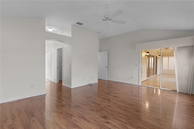 interior space featuring lofted ceiling, wood-type flooring, and ceiling fan