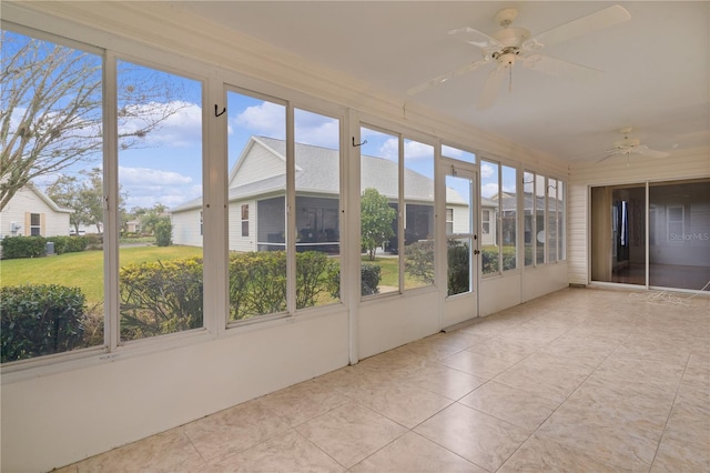 unfurnished sunroom with ceiling fan