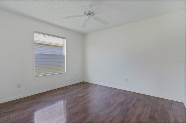 unfurnished room featuring ceiling fan, dark wood-type flooring, and a textured ceiling