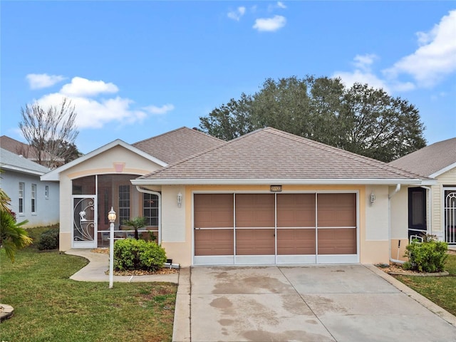 ranch-style home featuring a garage and a front yard