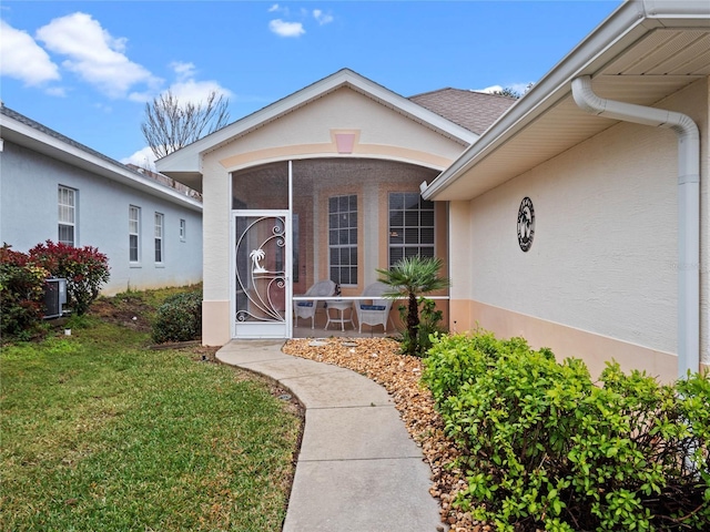 doorway to property featuring a yard