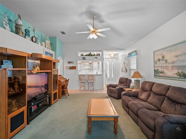 living room featuring a textured ceiling, ceiling fan, and carpet flooring