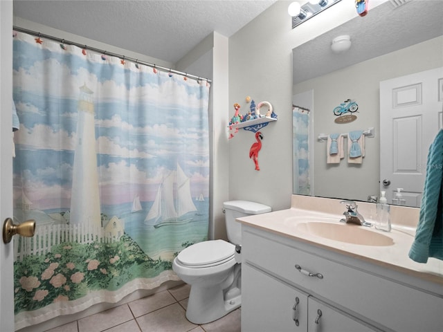 bathroom featuring vanity, a textured ceiling, tile patterned floors, and toilet