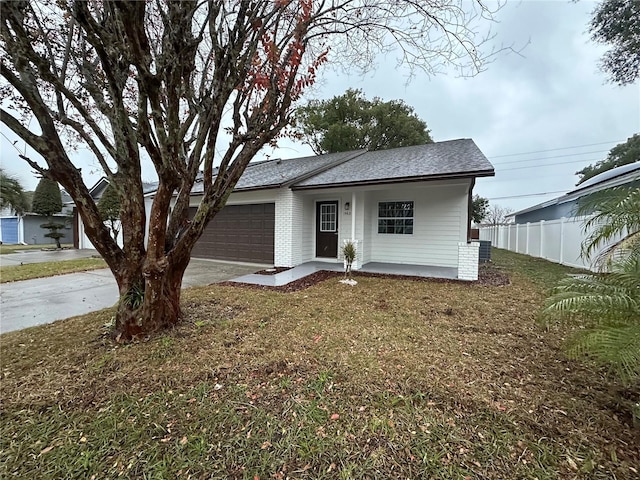 view of front of house featuring a porch, a garage, and a front lawn