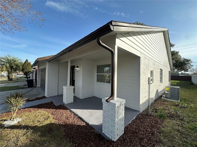 view of front of house featuring cooling unit and a garage