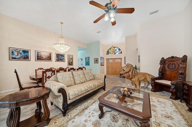 living room with ceiling fan with notable chandelier