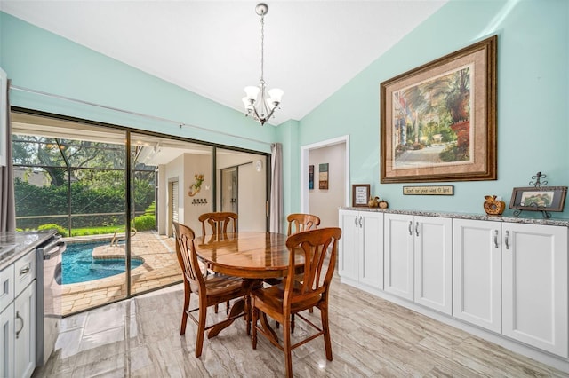 dining area with lofted ceiling and a chandelier