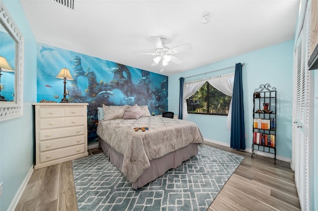 bedroom with ceiling fan and light hardwood / wood-style floors