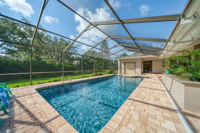 view of swimming pool with a patio and glass enclosure