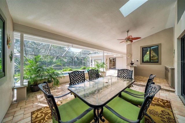 sunroom featuring lofted ceiling and ceiling fan