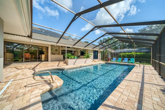 view of swimming pool with a patio and glass enclosure