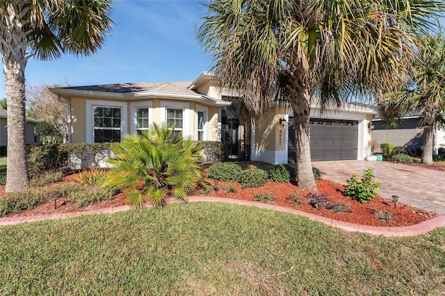 view of front of house featuring a garage and a front yard