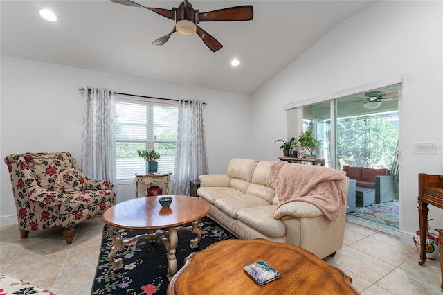 living room featuring ceiling fan, light tile patterned floors, and lofted ceiling