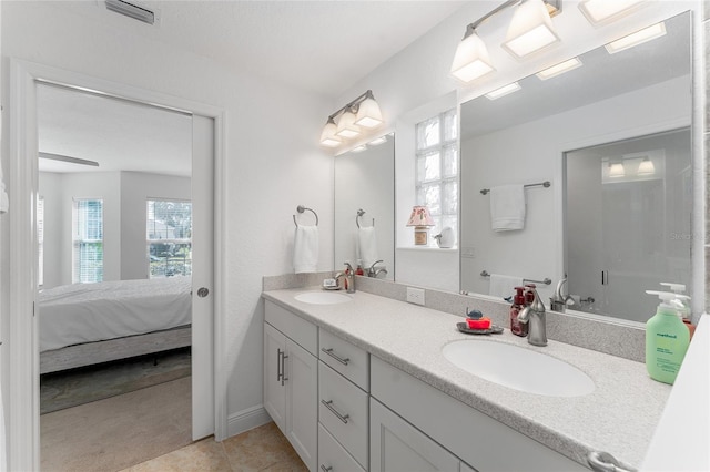 bathroom with tile patterned floors and vanity