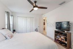 bedroom with ceiling fan and a closet