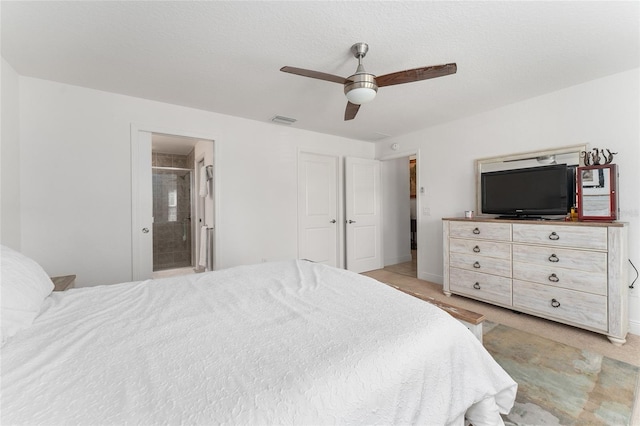 bedroom featuring ensuite bath and ceiling fan