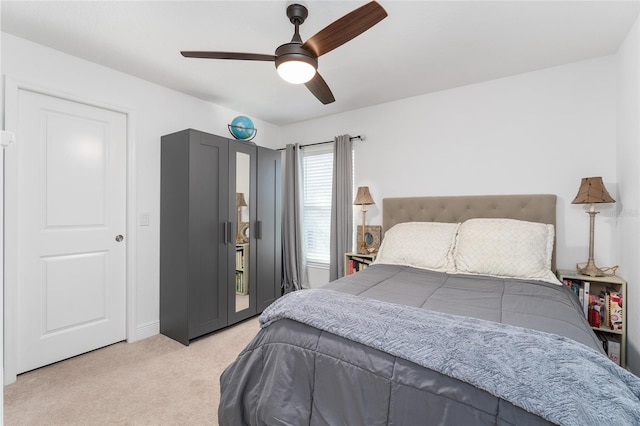 bedroom featuring ceiling fan and light carpet