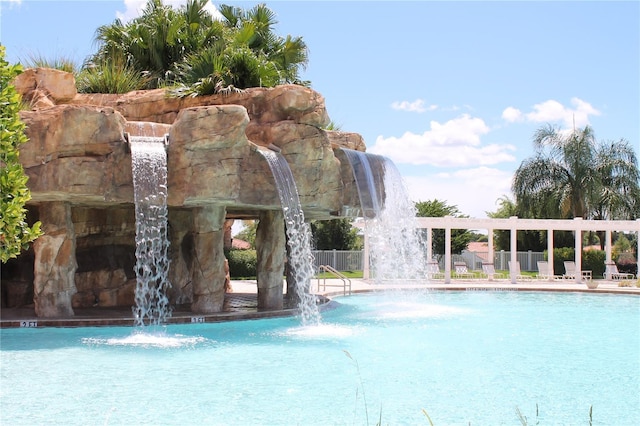 view of swimming pool featuring pool water feature