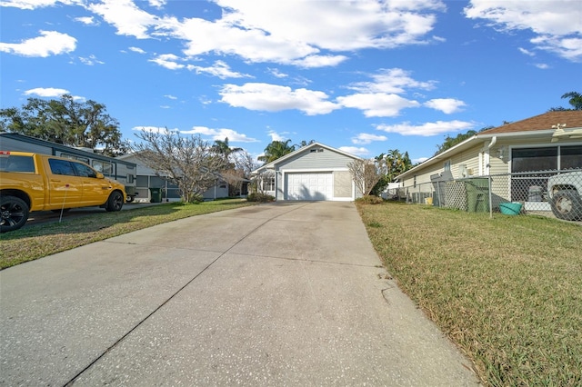 view of front of home featuring a garage, a front lawn, and an outbuilding